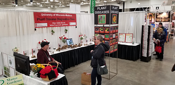 Brian Hudelson of the Plant Disease Diagnostic Clinic consults with a client at the Wisconsin Garden Expo.